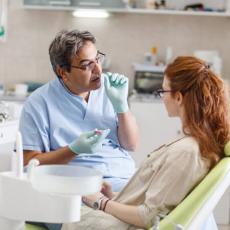 Dentist talking to dental patient