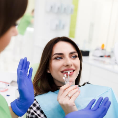 Woman in dental chair for smile makeover treatment planning visit