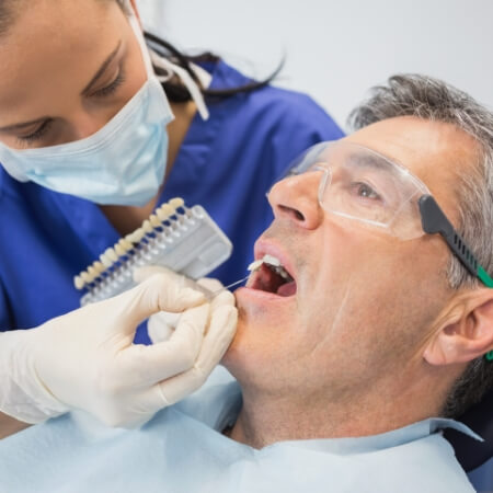 Dentistry patient's smile compared with dental bonding shade options