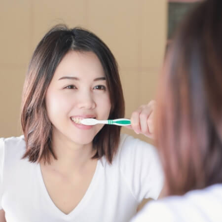 Woman brushing teeth