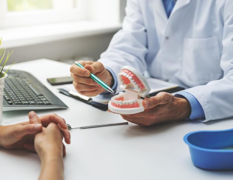 Dentist showing dental patient a smile model