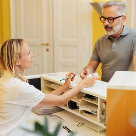 Dental team member talking to dentistry patient