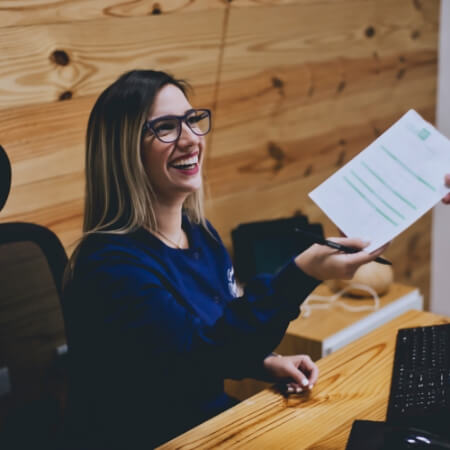 Dental team member smiling behind the reception desk