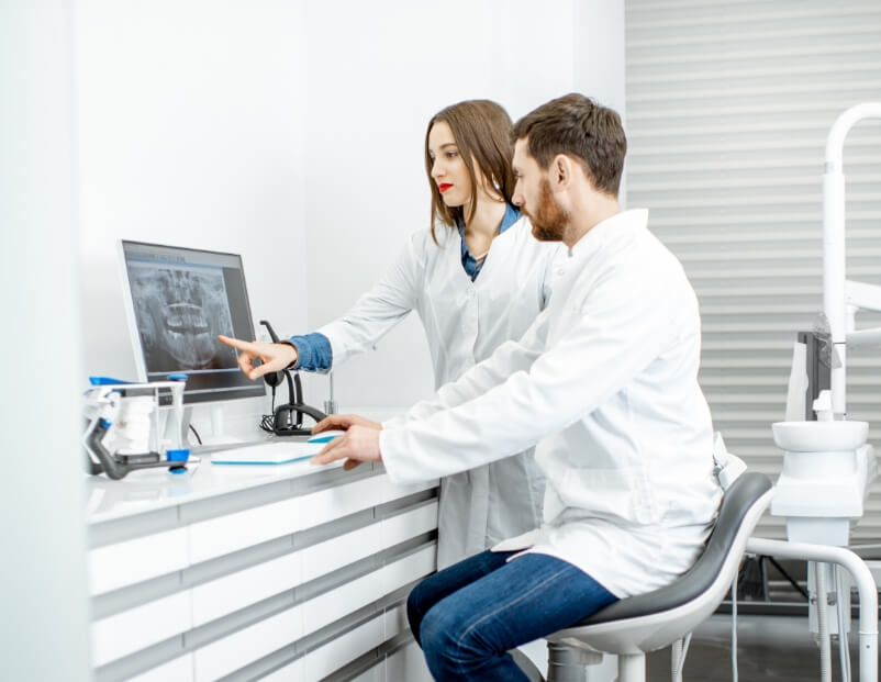 Dental team members looking at computer