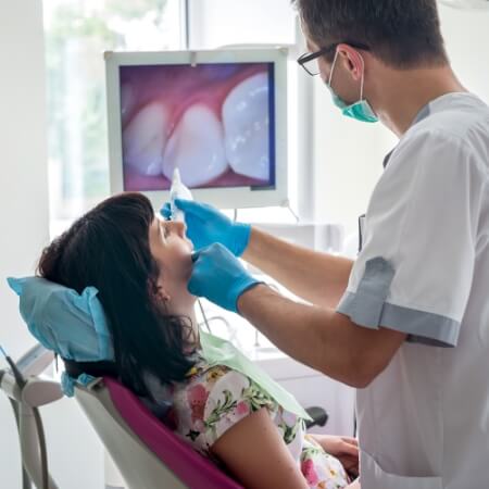 Dentist using intraoral camera to capture smile images