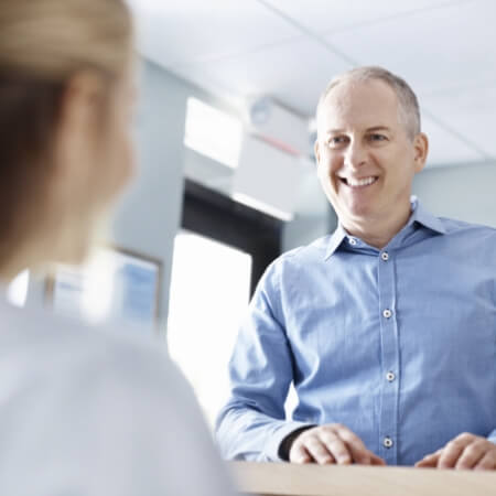 Dental patient talking to dental team member