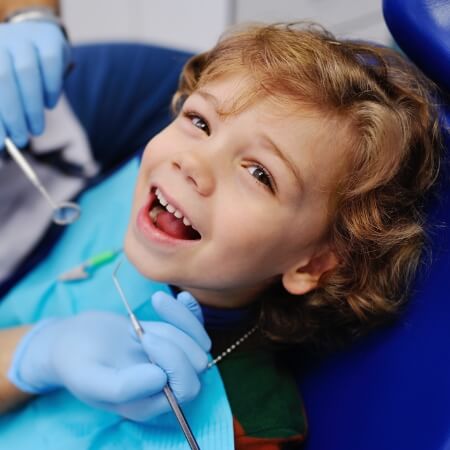 Child laughing during children's dentistry visit