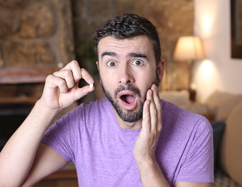 Man holding tooth in need of option to replace missing teeth