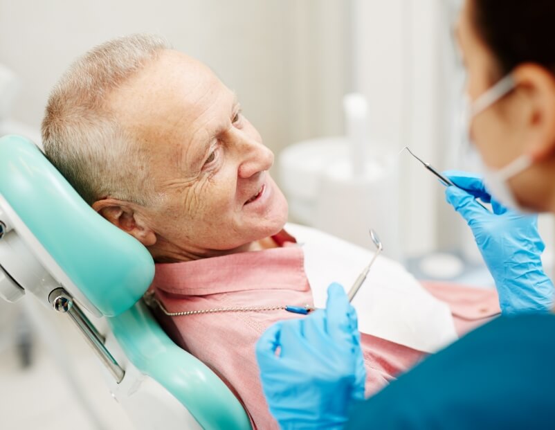 Older man receiving oral cancer screening
