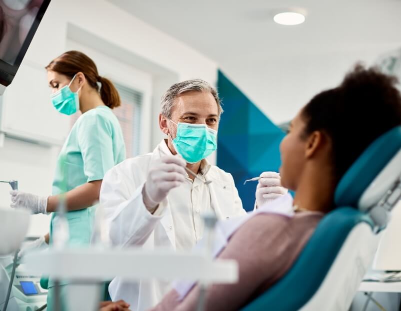 Dentist talking to dental patient