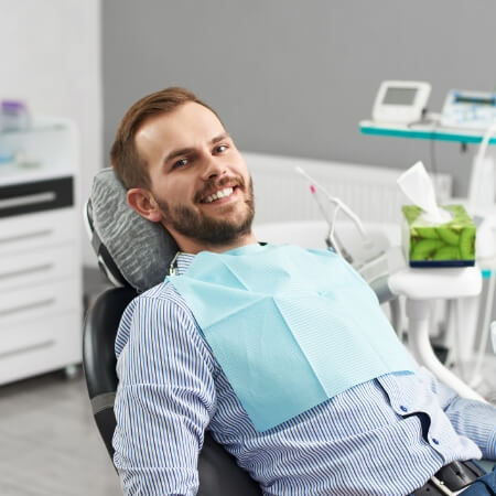 Man smiling during dental checkup and teeth cleaning visit