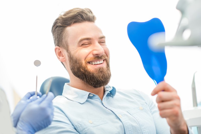 patient smiling while visiting dentist for checkup 